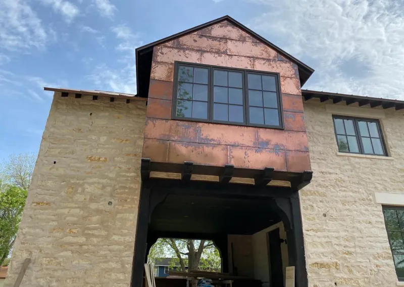 Copper metal panel facade on a stone building for Skylight Installation in West Carrollton